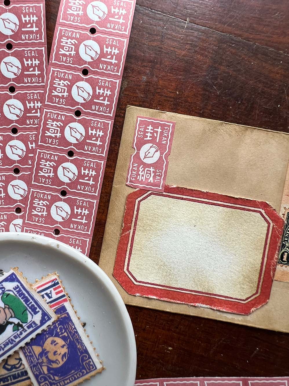 36 Sublo Ticket Roll Stickers: Fountain Pen FUKAN Seal (Taster 30 pc) from micmoc.com - Collection of vintage stamps and labels on a wooden desk